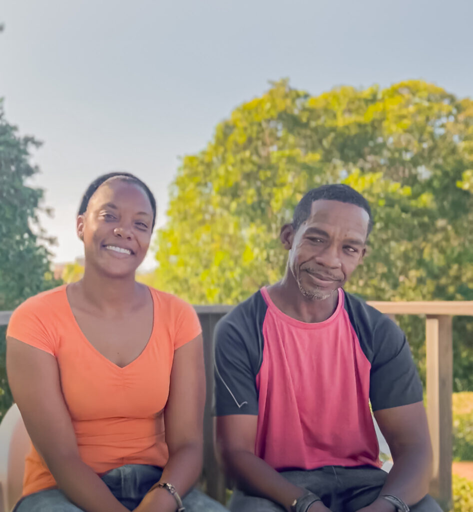 Man and woman smiling together outdoors.